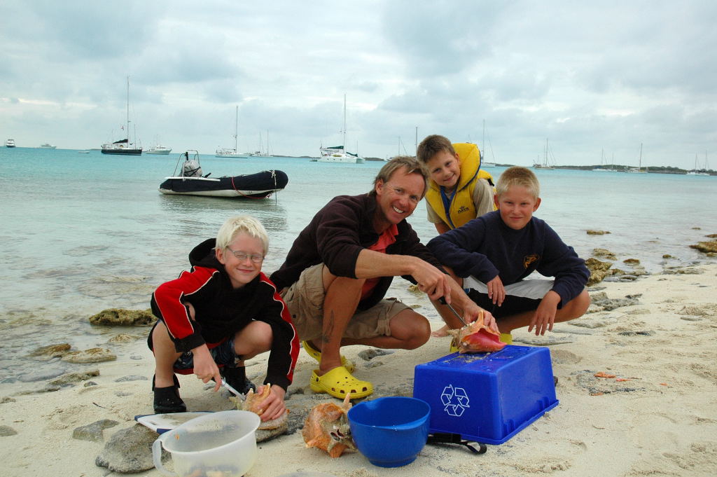 Preparing Conch for dinner with the buys from the sailboat Priority.