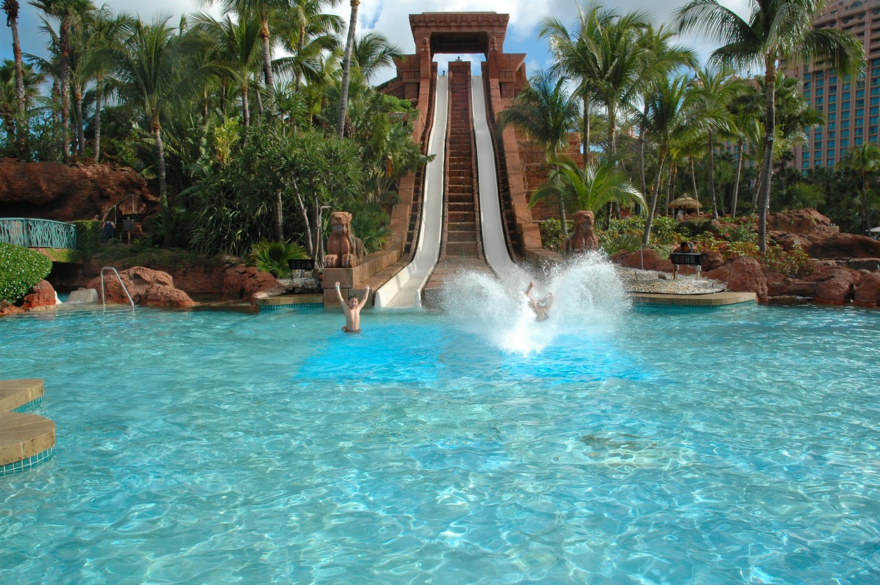 My dad and I racing down the water slide, my dad on the right with the big splash.